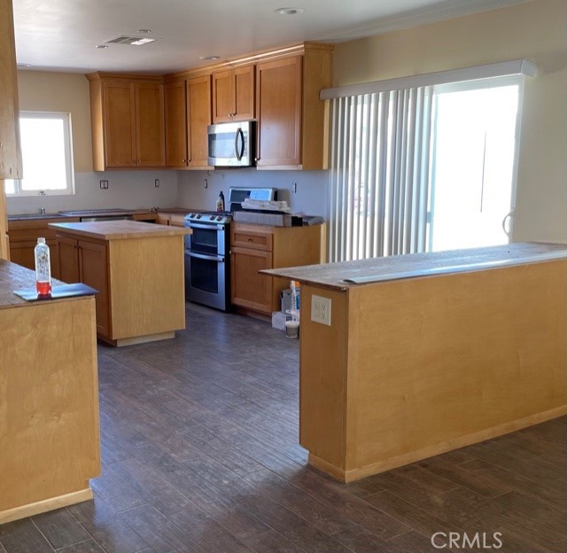 10645 East Ave R 12 Littlerock, CA 93543 - Photo 5 of 23 a kitchen with kitchen island granite countertop wooden floors and a sink