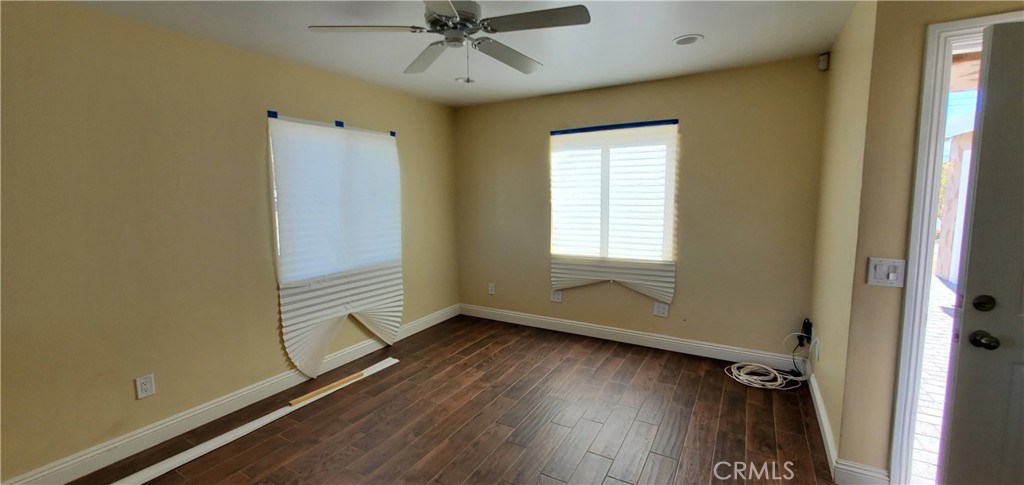 10645 East Ave R 12 Littlerock, CA 93543 - Photo 9 of 23 a view of room with window ceiling fan and hardwood floor