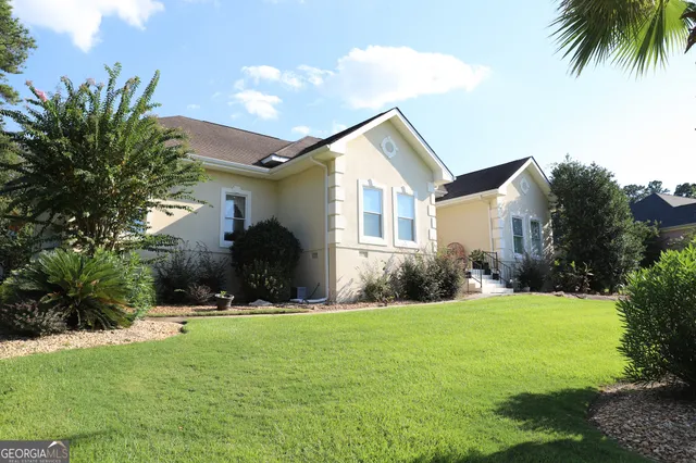 a view of a patio with couches table and chairs and potted plants