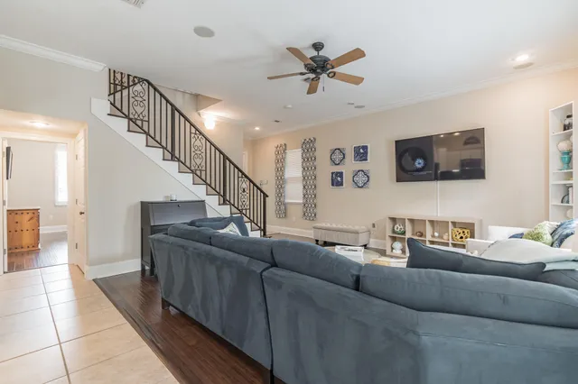 a living room with couches and a view of kitchen