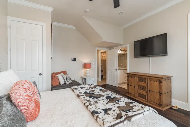 a bedroom with furniture and a flat screen tv
