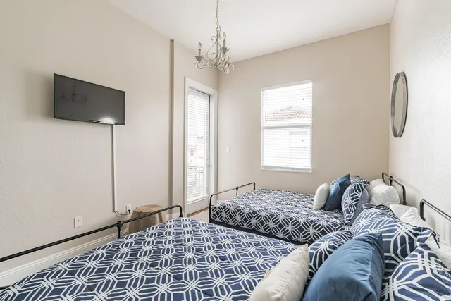 a bedroom with a bed and a window