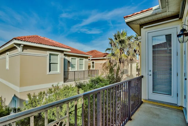 a yellow house with trees in front of it