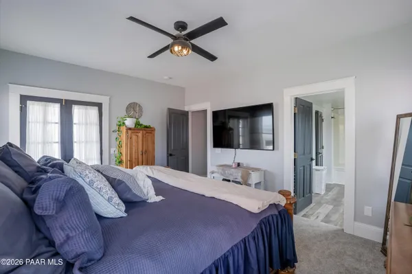 a view of a roof deck with table and chairs with wooden floor and fence