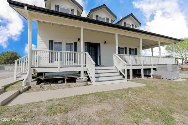 a kitchen with stainless steel appliances granite countertop a kitchen island a stove a table and chairs