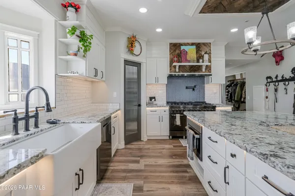 a bedroom with a large bed a flat tv screen and a dresser