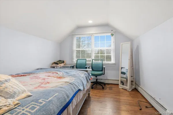 a bedroom with bed and a window