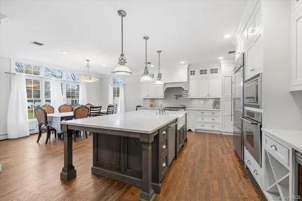 a open kitchen with stainless steel appliances granite countertop a stove and refrigerator