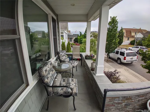 a living room with patio furniture and a floor to ceiling window