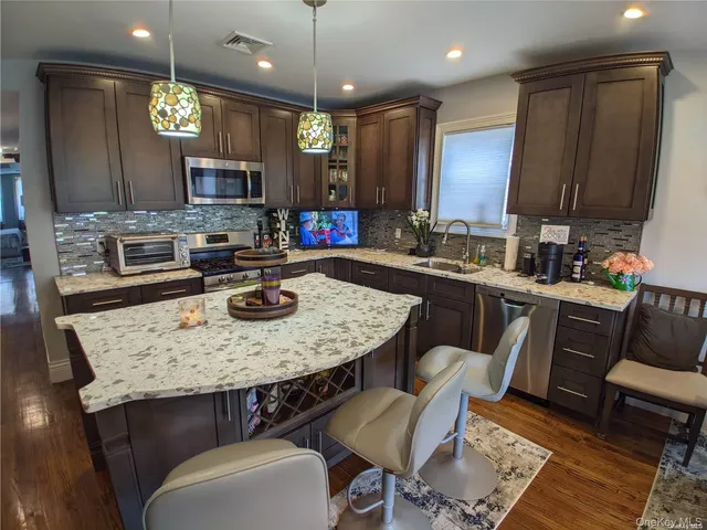 a kitchen with a table chairs sink and microwave