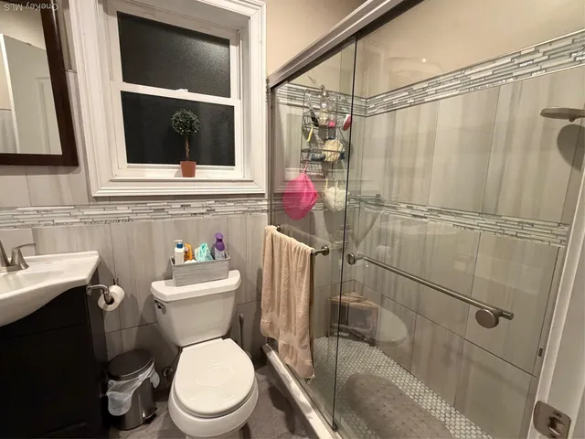 a bathroom with a toilet sink and shower