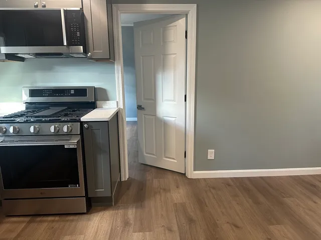 a stove top oven sitting inside of a kitchen