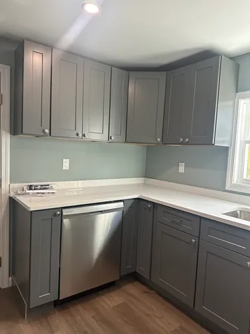 a kitchen with wooden cabinets and white appliances