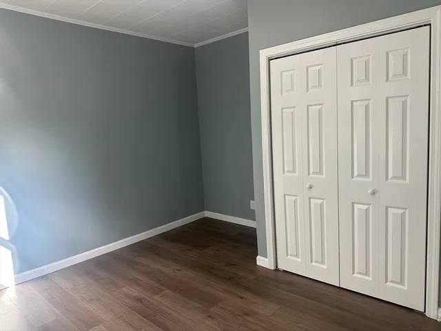 an empty room with wooden floor