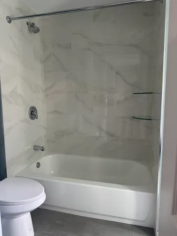 a bathroom with a bathtub and a toilet