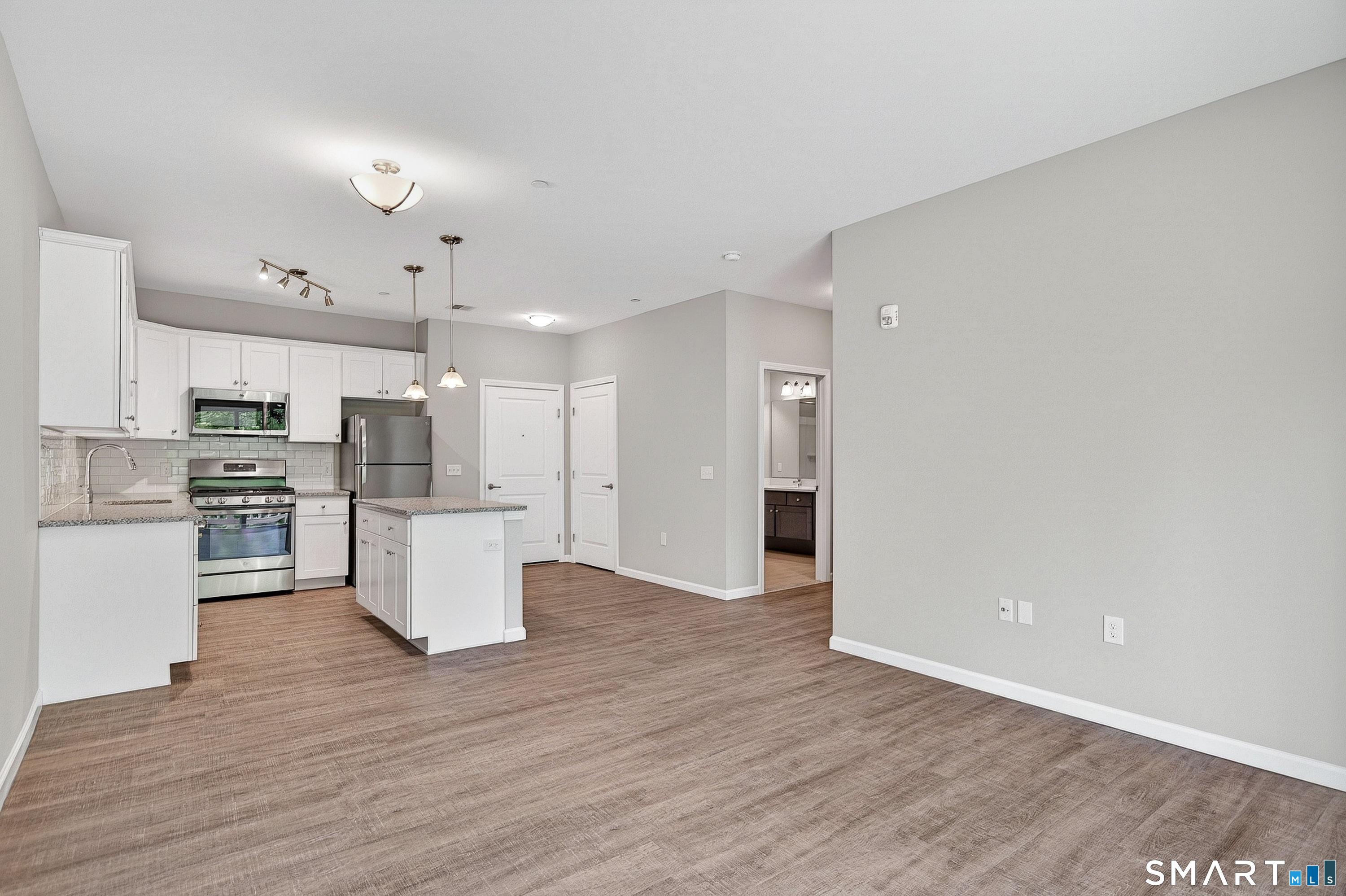 9 Covered Bridge Road, Unit 5107 Newtown, CT 06470 - Photo 27 of 27 Spacious living room with open floor plan.