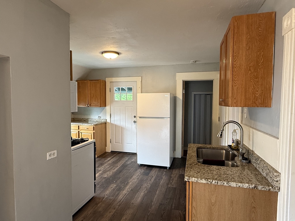 5 Arbor Vitae Street, Unit 2 Worcester, MA 01603 - Photo 3 of 12 a kitchen with a refrigerator sink and stove