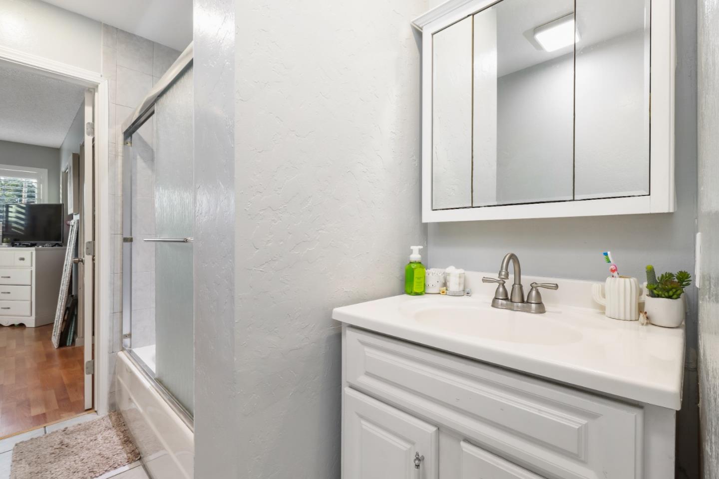 3784 Timberline Drive San Jose, CA 95121 - Photo 16 of 17 a bathroom with a sink and a mirror