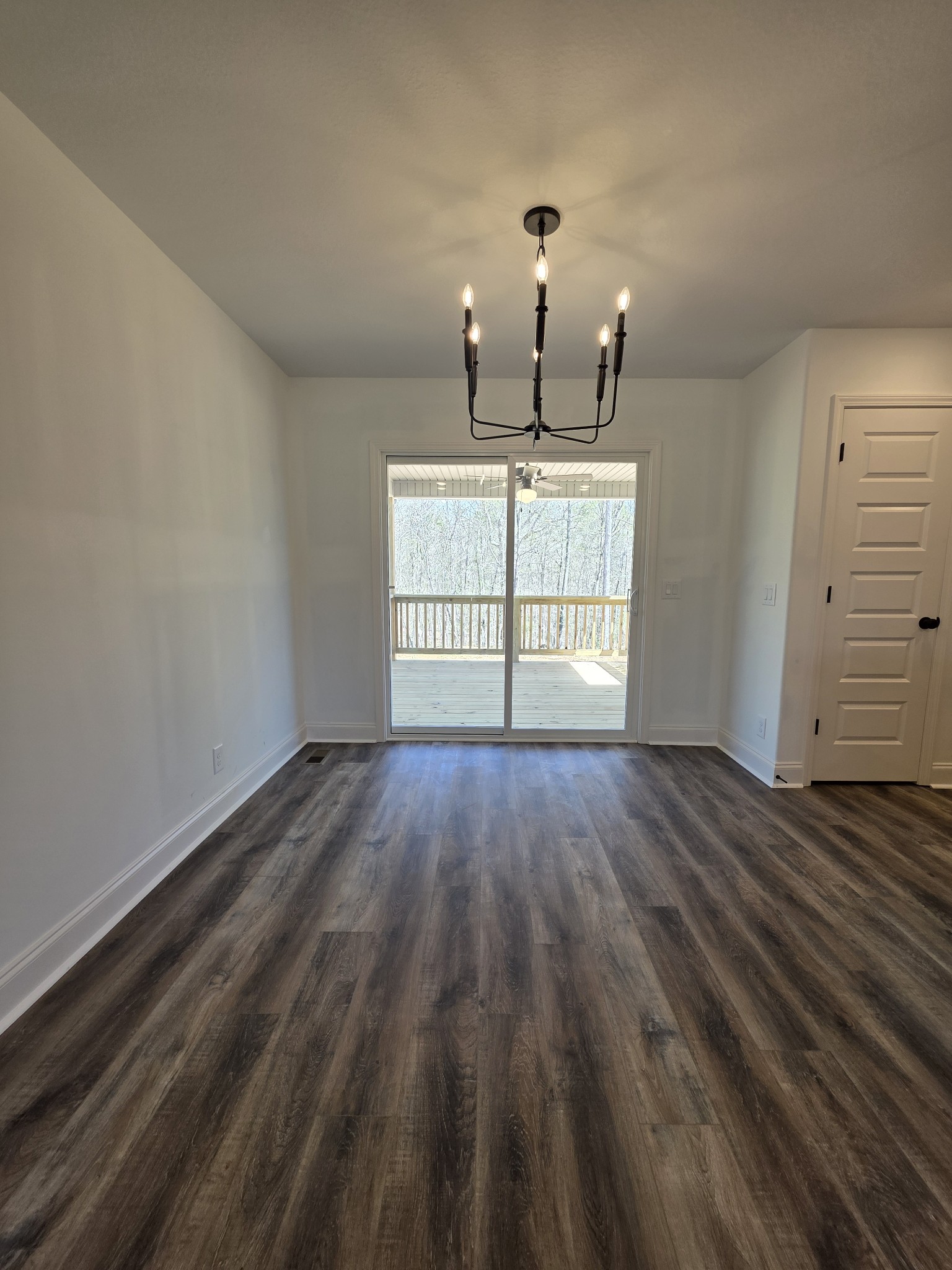475 Ridge Top Court Clarksville, TN 37040 - Photo 7 of 44 an empty room with wooden floor chandelier and windows