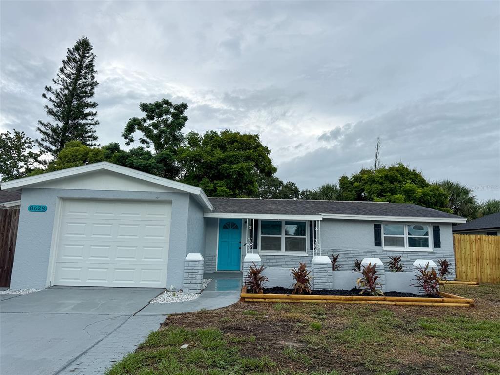 8628 Roble Way Port Richey, FL 34668 - Photo 1 of 1 a front view of house with outdoor seating and yard