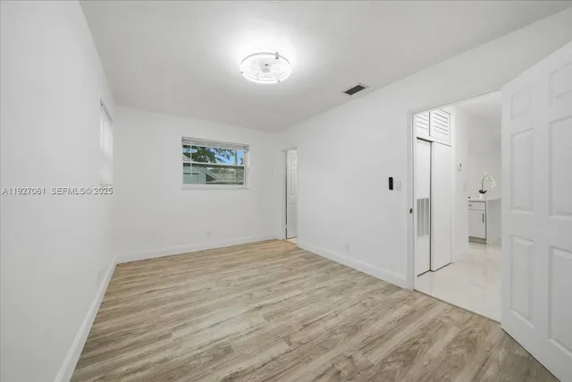 a view of room with window and ceiling fan