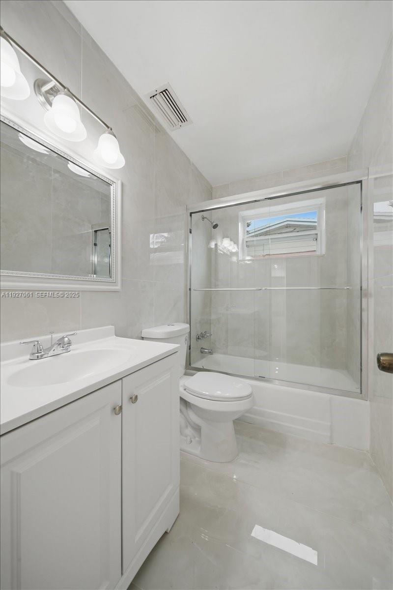 3330 North 72nd Terrace Hollywood, FL 33024 - Photo 21 of 32 a bathroom with a shower sink vanity mirror and toilet