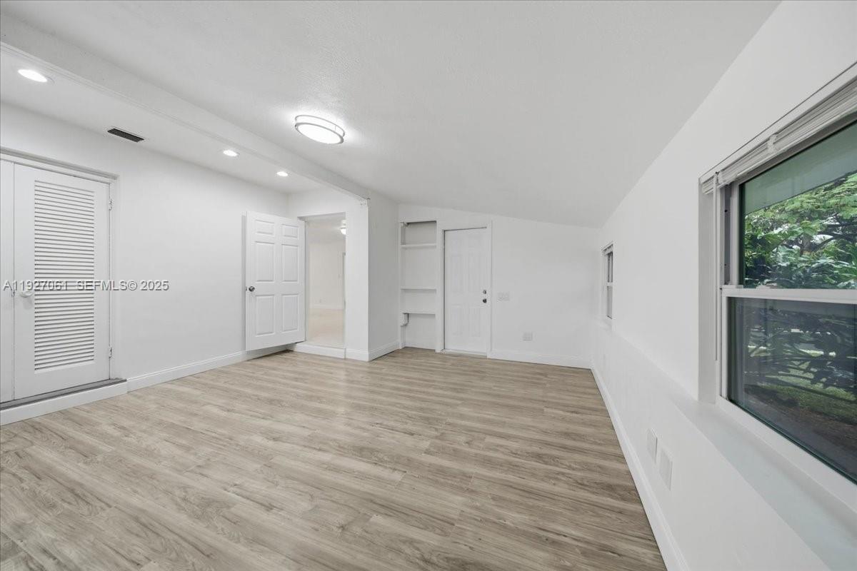 3330 North 72nd Terrace Hollywood, FL 33024 - Photo 23 of 32 a view of an empty room with wooden floor and a window