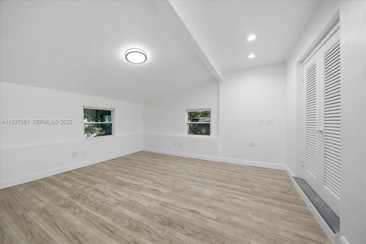 3330 North 72nd Terrace Hollywood, FL 33024 - Photo 30 of 32 an empty room with wooden floor and windows