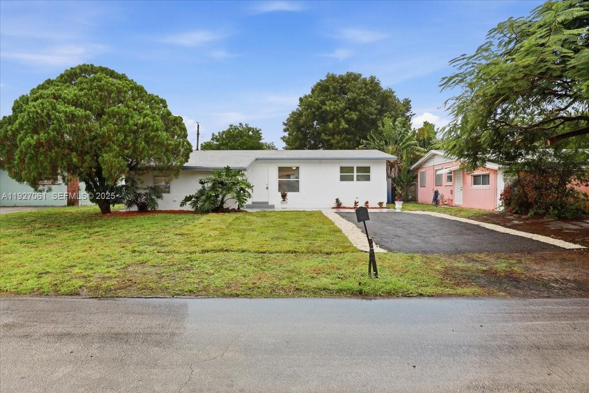 3330 North 72nd Terrace Hollywood, FL 33024 - Photo 3 of 32 a front view of a house with garden