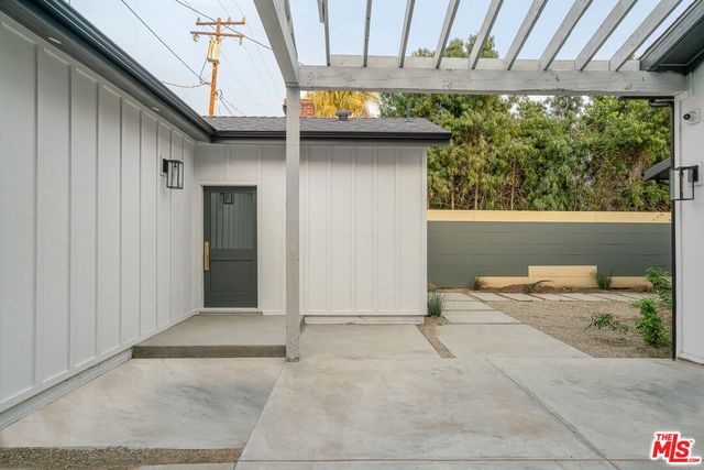 an empty room with wooden floor and entrance