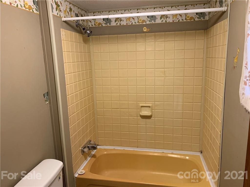 326 Indian Springs Road Clyde, NC 28721 - Photo 11 of 19 a bathroom with a blue tub shower