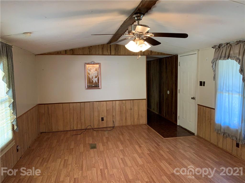 326 Indian Springs Road Clyde, NC 28721 - Photo 6 of 19 wooden floor in an empty room with a window