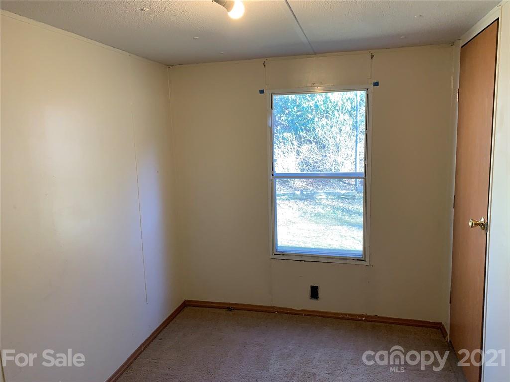 326 Indian Springs Road Clyde, NC 28721 - Photo 8 of 19 a view of an empty room with a window