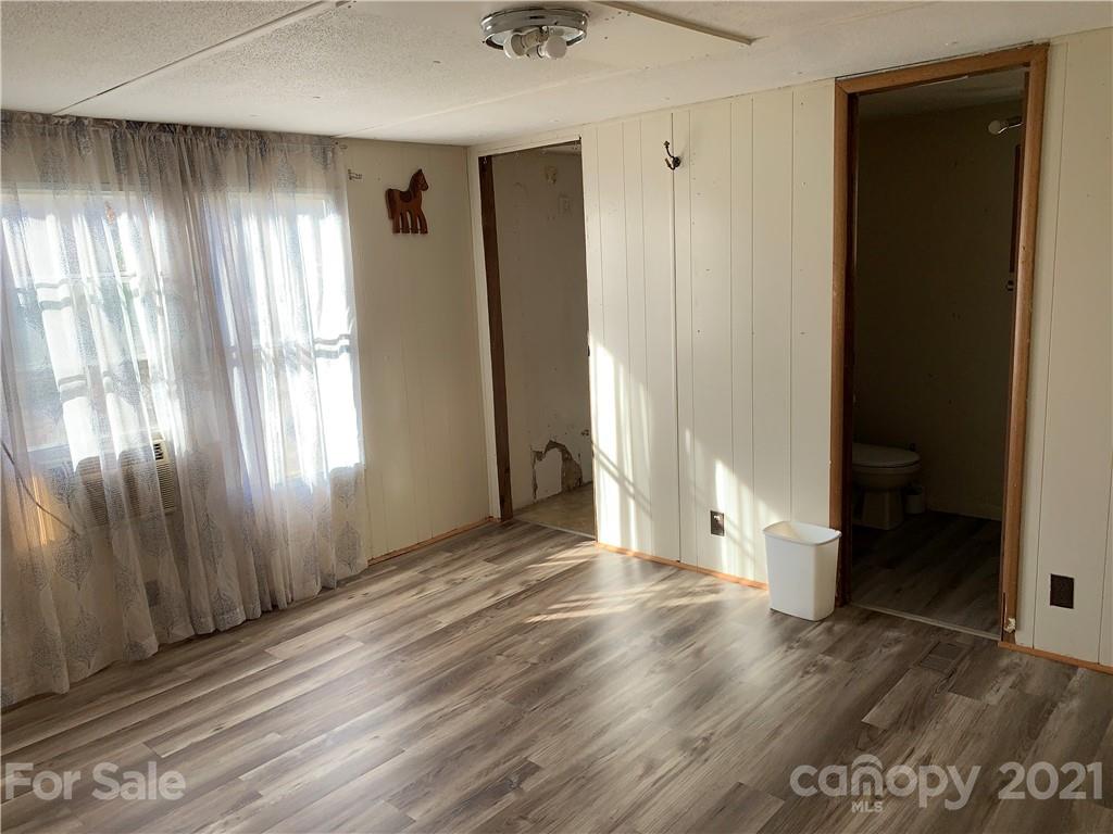 326 Indian Springs Road Clyde, NC 28721 - Photo 10 of 19 wooden floor in an empty room