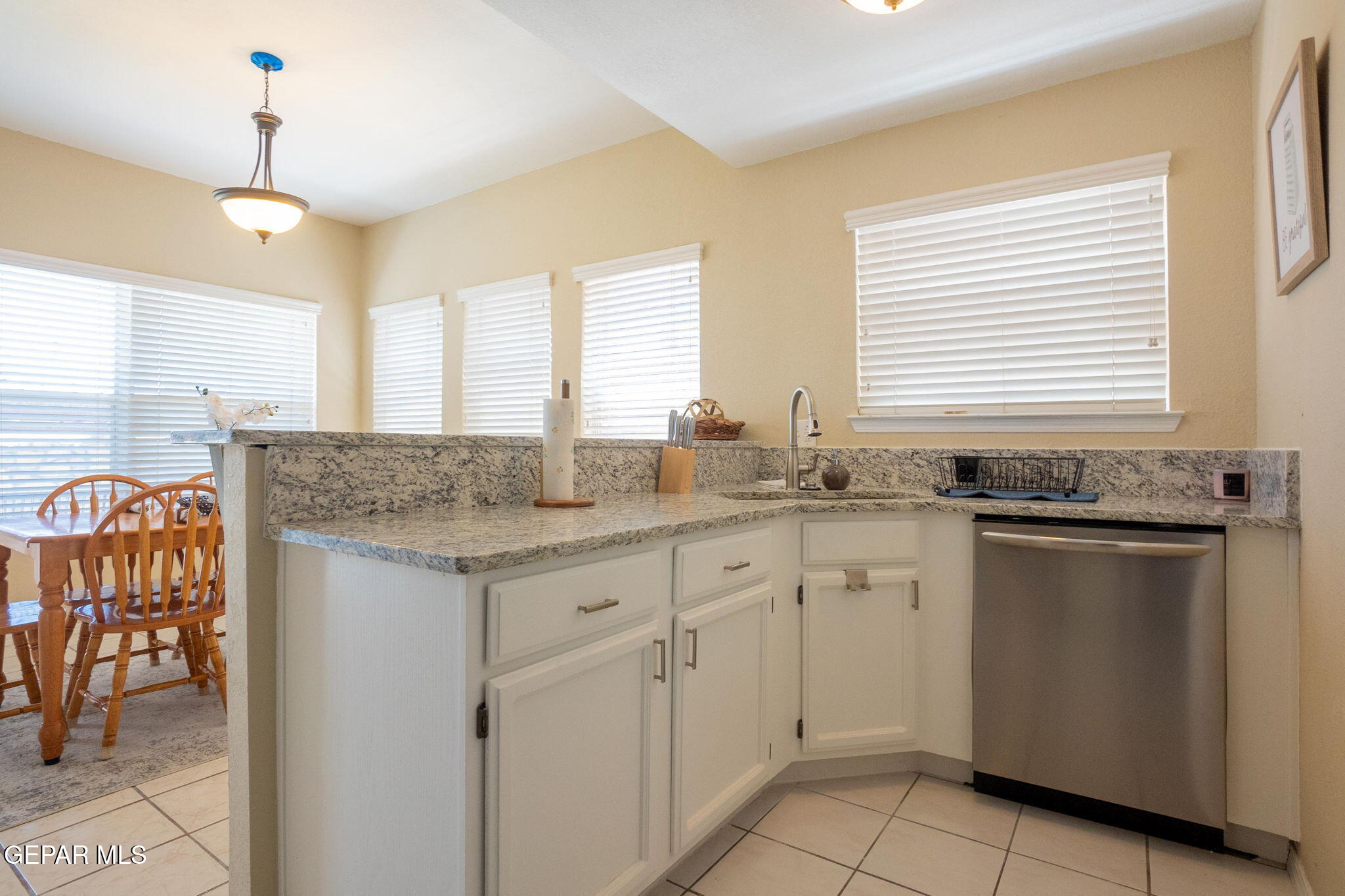 2012 Rogelio Avenue El Paso, TX 79902 - Photo 6 of 12 a kitchen with granite countertop cabinets stainless steel appliances a sink and a window