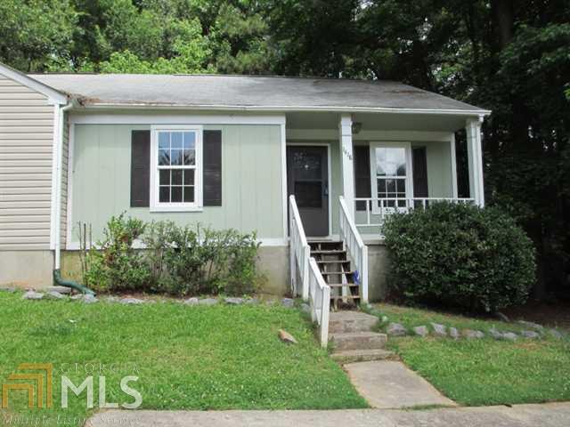 1418 West Booth Rd Extension Southwest Marietta, GA 30008 - Photo 1 of 1 a front view of a house with a yard