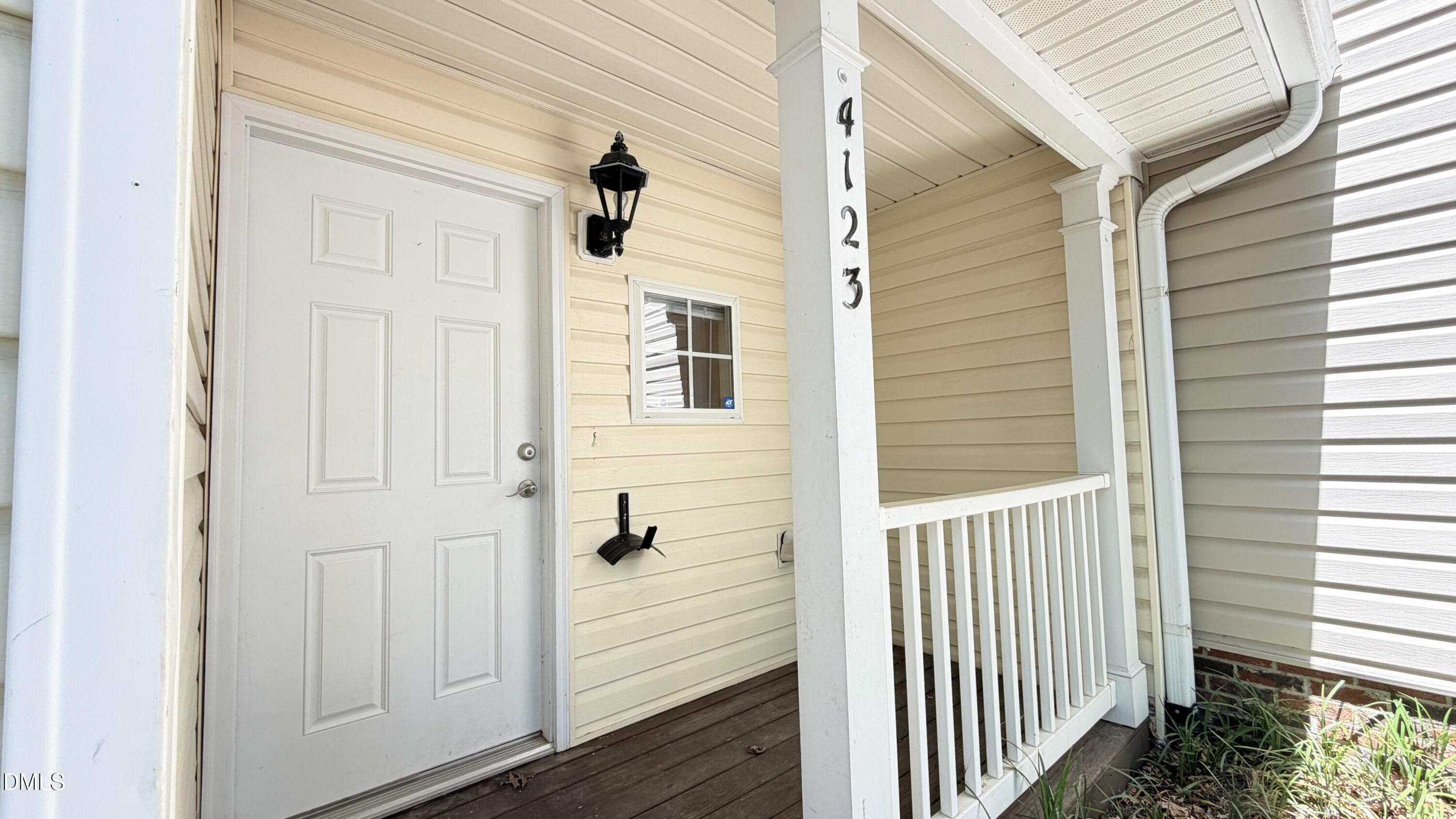 4123 Standing Rock Way Raleigh, NC 27604 - Photo 28 of 29 a view of a wooden door and a window