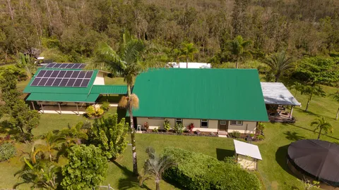 an aerial view of a house with garden space and street view