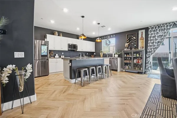 a kitchen with stainless steel appliances granite countertop a stove top oven a sink a counter top space and cabinets