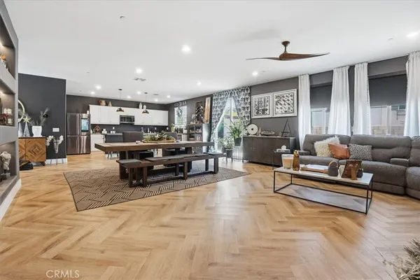 a view of a hallway with wooden floor and a potted plant