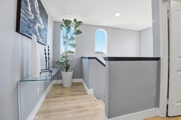 a bedroom with a bed next to a window and a flat screen tv