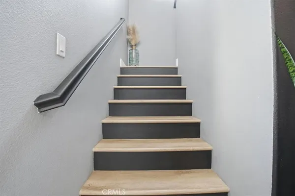 a bedroom with a large bed couch and a window