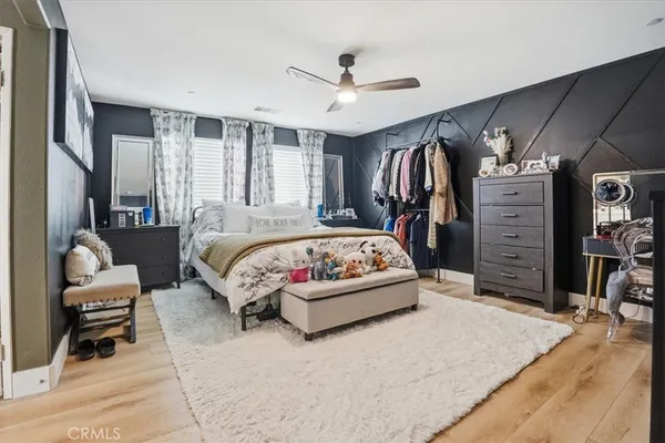 a bedroom with a bed and a painting on the wall