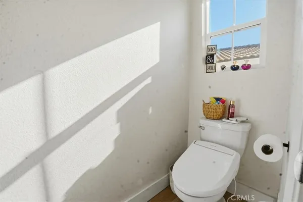 a bathroom with a sink a toilet and shower curtain