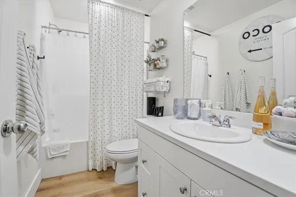 a view of a patio with couches and table and chairs and potted plants