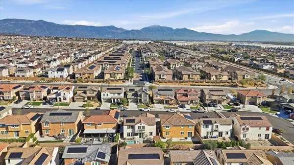 a living room with furniture a rug and kitchen view