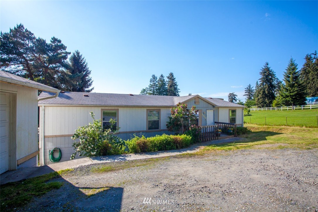 5390 East Harbor Road Freeland, WA 98249 - Photo 1 of 17 a view of a house with backyard and garden