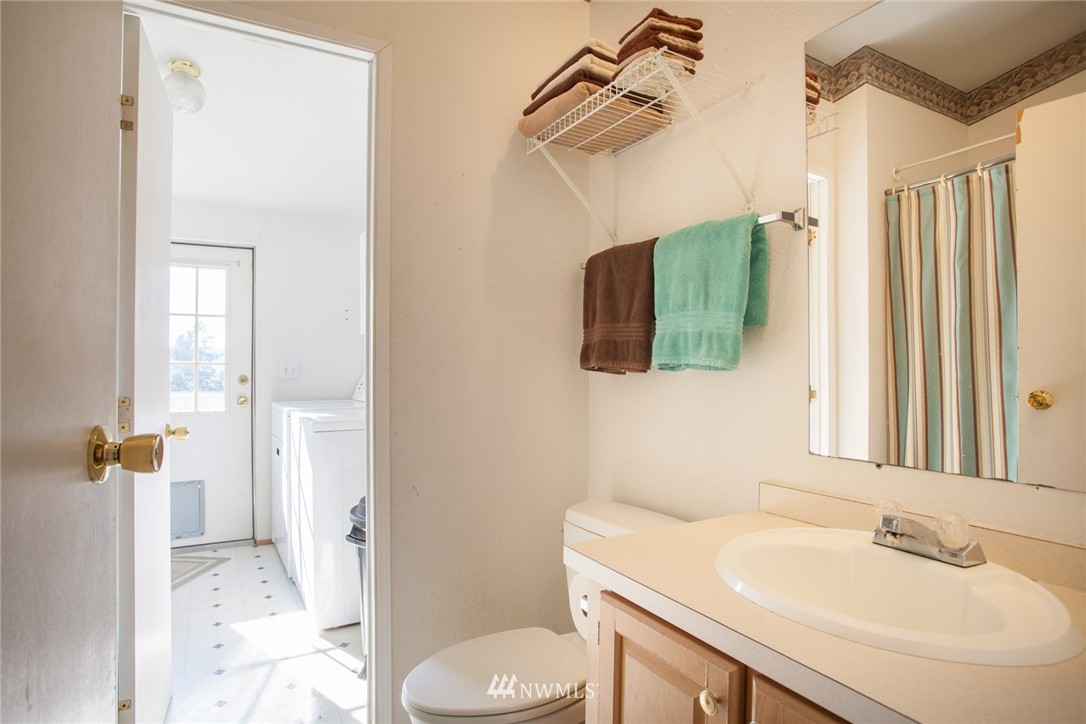 5390 East Harbor Road Freeland, WA 98249 - Photo 14 of 17 a bathroom with a sink toilet and shower