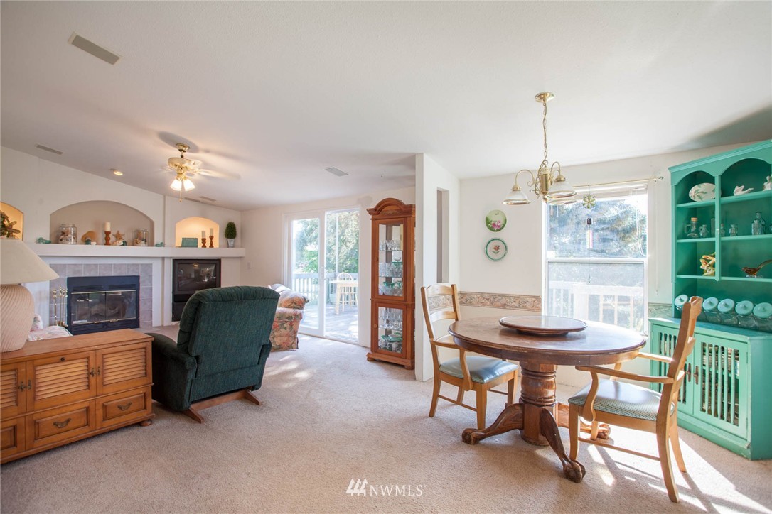 5390 East Harbor Road Freeland, WA 98249 - Photo 5 of 17 a living room with furniture and a fireplace