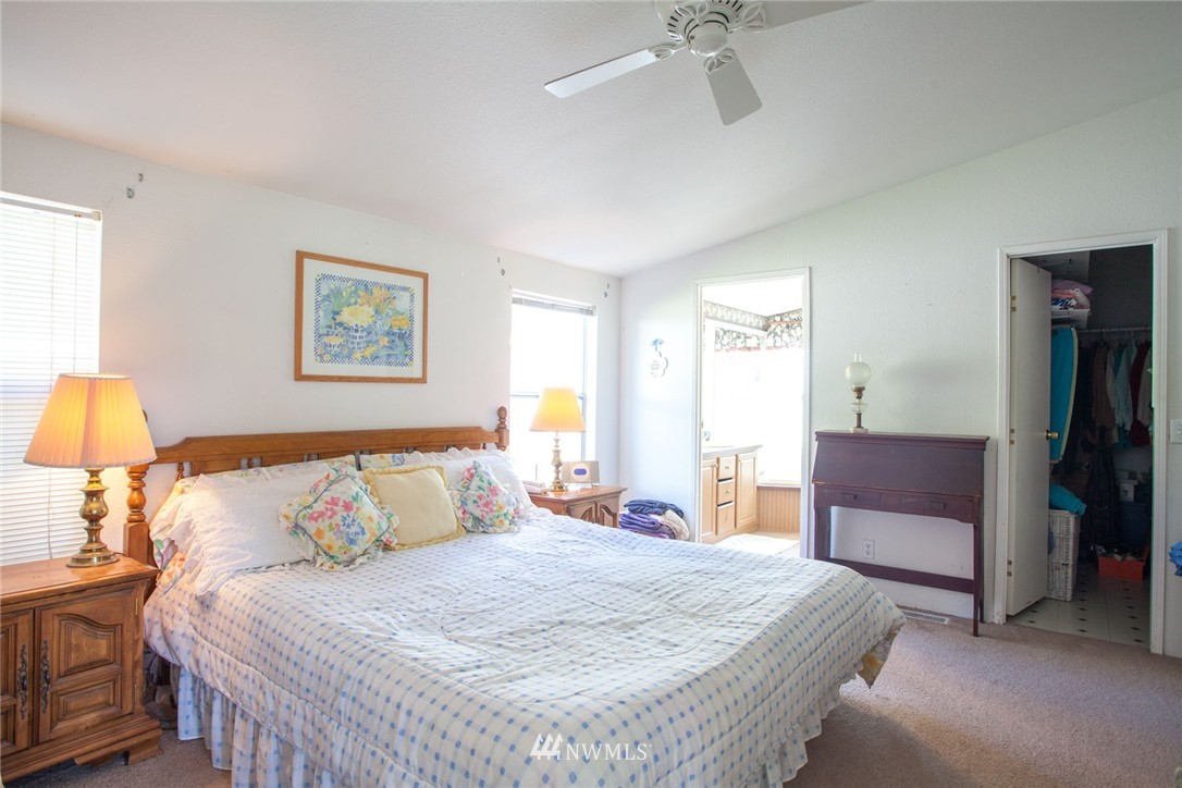 5390 East Harbor Road Freeland, WA 98249 - Photo 9 of 17 a bedroom with a bed and a dresser